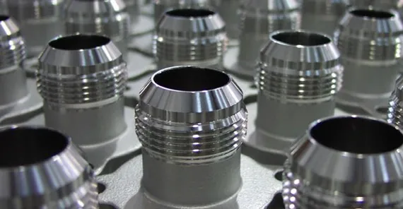 Cleaned stainless steel fittings prepared for oxygen service at Harrison Electropolishing