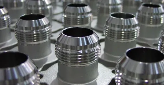 Electropolished stainless steel sanitary ferrules showing a uniform bright finish at Harrison Electropolishing